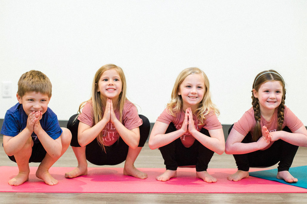 Kids practicing yoga Squat Pose